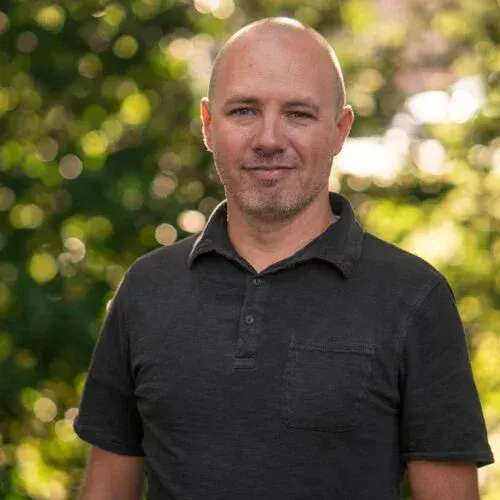 Compassionate man outdoors, spiritual church community support, faith-based outreach.